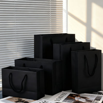 Guter Preis Black Cardboard Bag Custom Paper Tote Packaging Bag Black Kraft Paper Bag Clothing Store Tote Bag Online